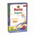 A box of Holle Organic Banana Cereals with Milk, designed for babies from 6 months. The packaging features a white front with purple borders, red and green text, and illustrations of a banana, a bowl of cereal, and wheat.