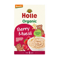 A box of Holle Organic Berry Muesli by Demeter, featuring a cream-colored background with red and green text, illustrations of cartoon bears, and a bowl of the muesli with berries on the front.