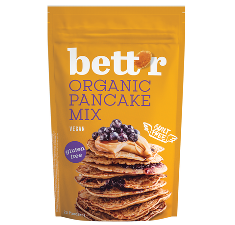 A package of Bettr Organic Pancake Mix with a stack of pancakes with blueberries on top, alongside a text that highlights the vegan and gluten-free features.